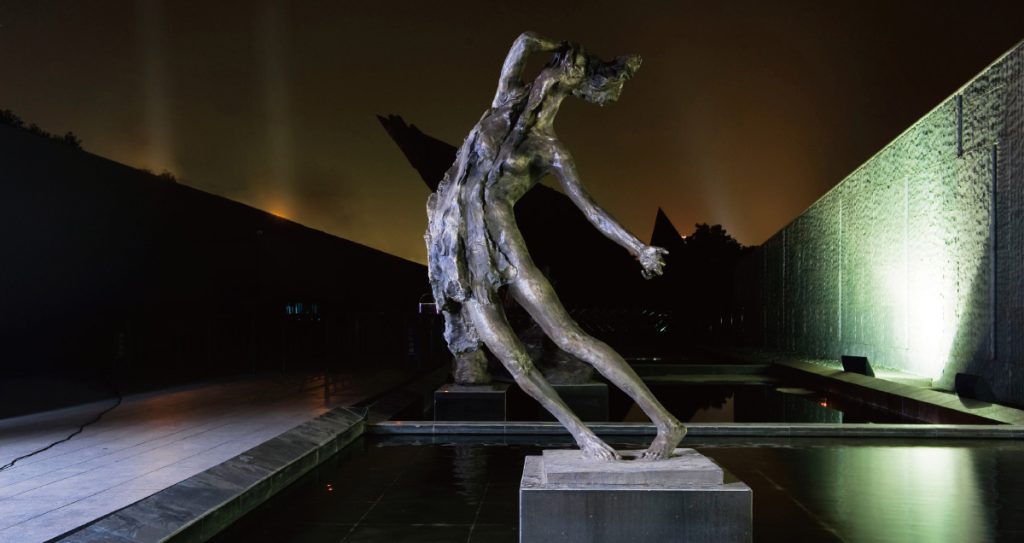 Abstract human sculpture at night